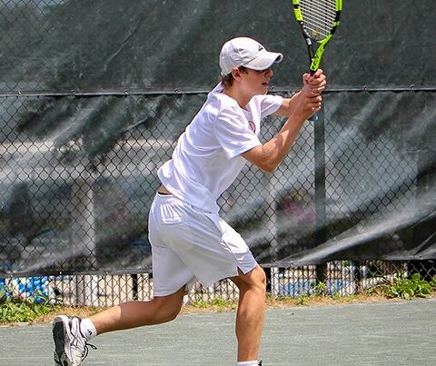 Visually impaired teenage boy playing tennis