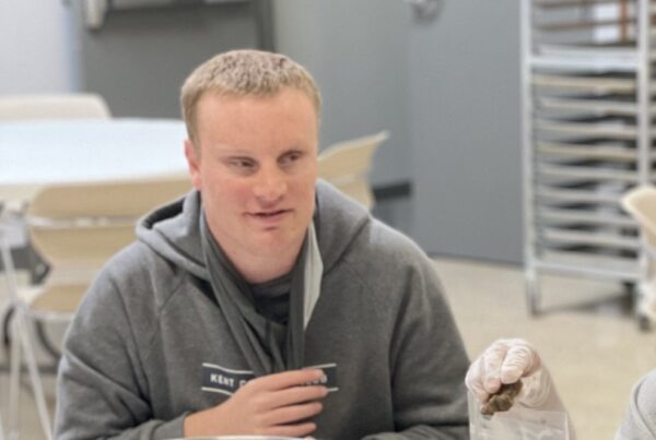 Visually impaired young mad sitting in a commercial kitchen