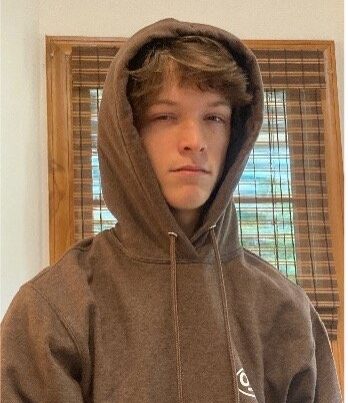 Teenage boy in a brown hoodie