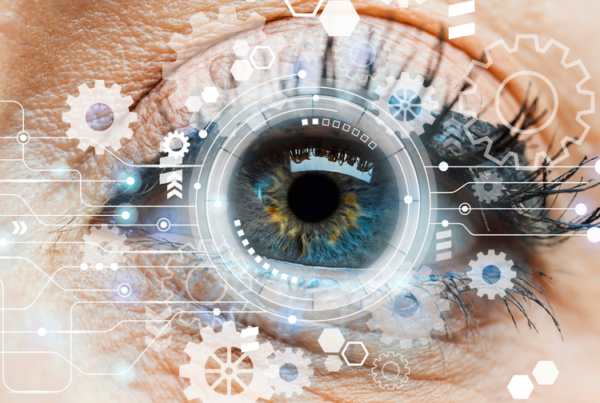 Photo of an eye with white camera and gear graphics