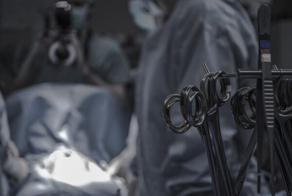 Doctors performing surgery with surgical utensils