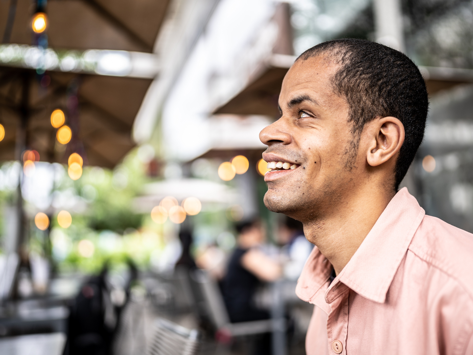 Smiling visually impaired man near outside shops