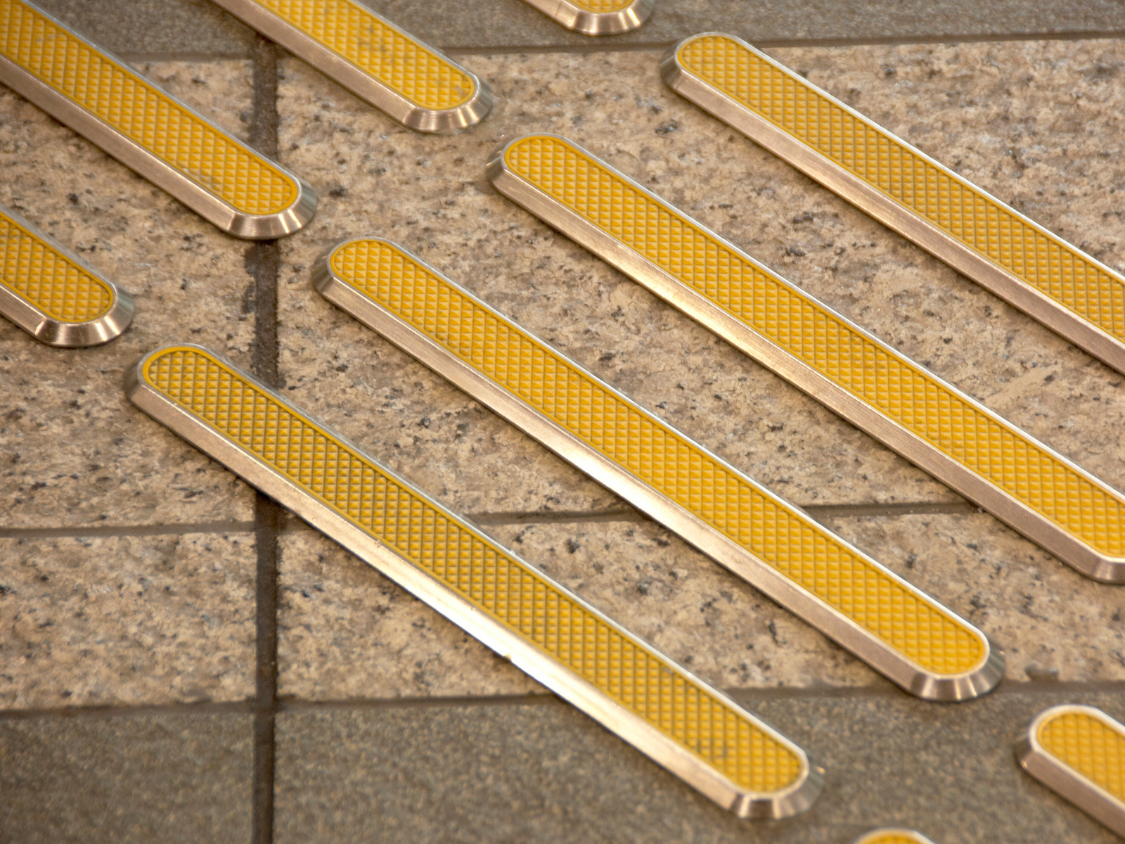 Bumpy yellow textured tiles that inform pedestrians they are nearing a potentially dangerous area